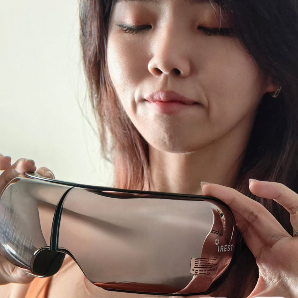Tired lady putting on her iREST EyeWell Relaxing Massager
