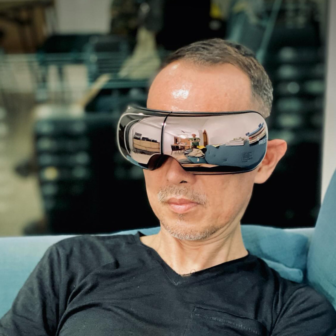 Man unwinding with iREST EyeWell Relaxing Massager