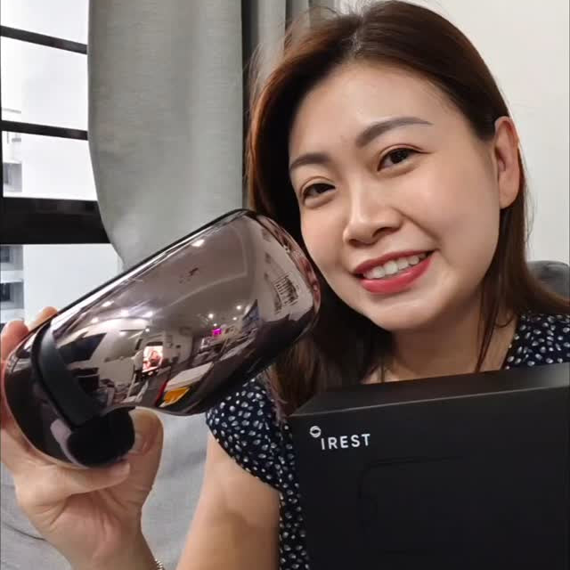 Lady happily showing her iREST EyeWell Relaxing Massager