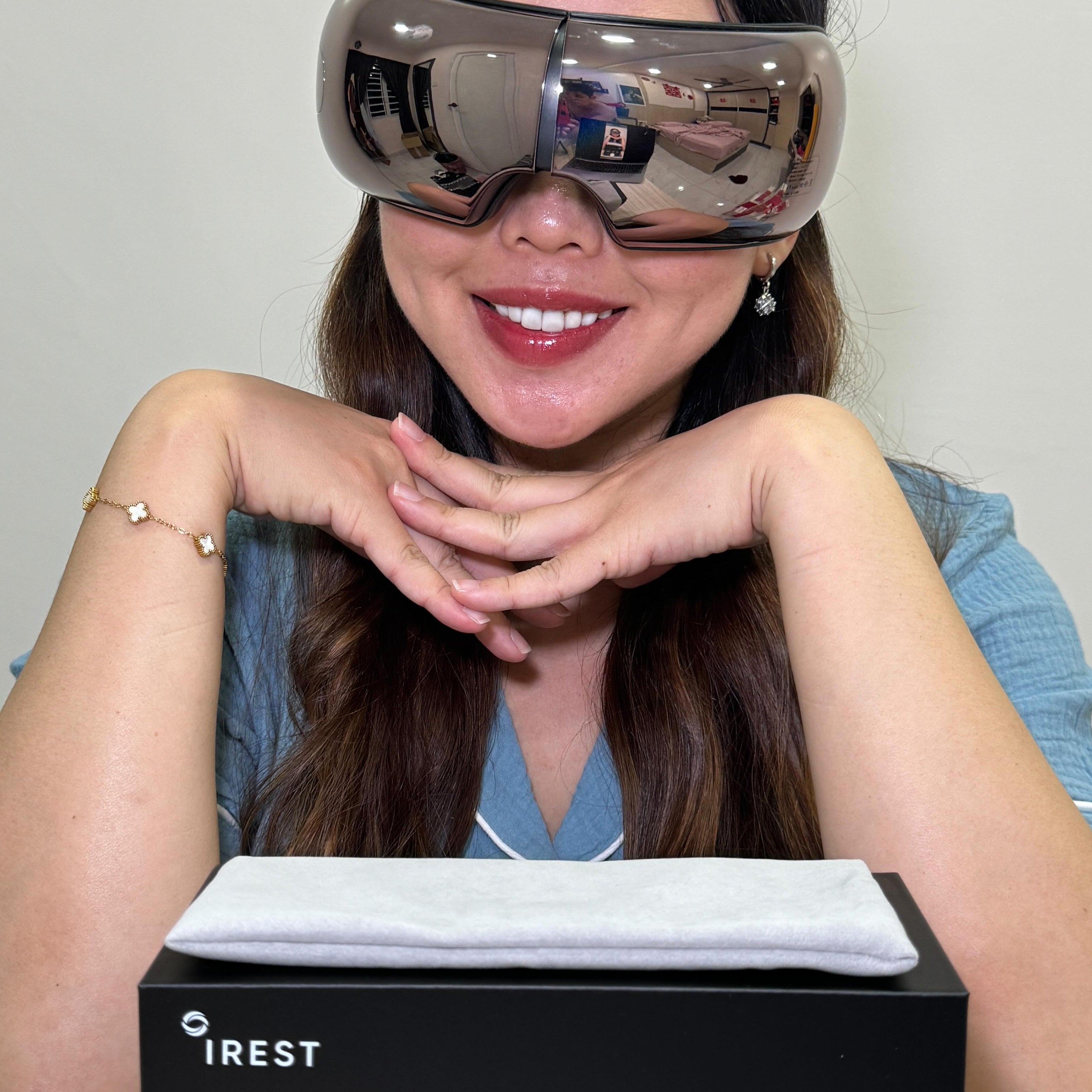 Lady happily showing her iREST EyeWell Relaxing Massager